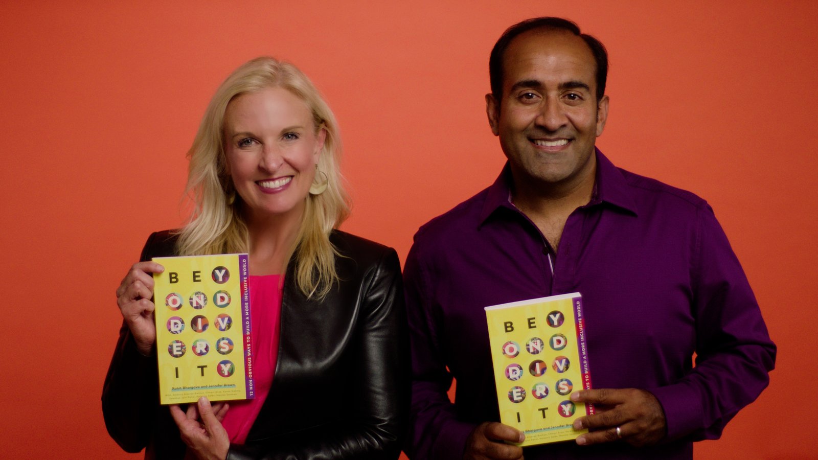 Rohit and Jennifer Brown holding copies of Beyond Diversity